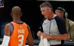 Referee Scott Foster talks with Phoenix Suns guard Chris Paul (3) before the start of Game 6 of basketball’s NBA Finals against the Milwaukee Bucks 