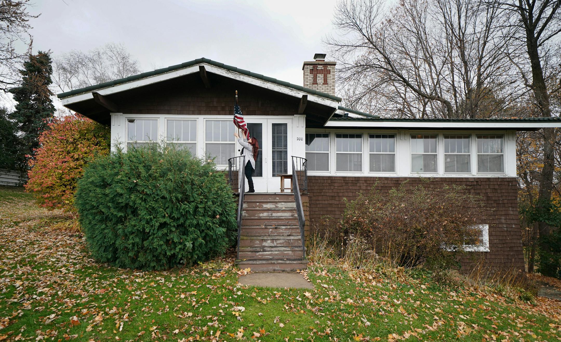 Pam Koenig fixed the American flag by the front entrance of the home she and Peter Kizilos-Clift hope to preserve.