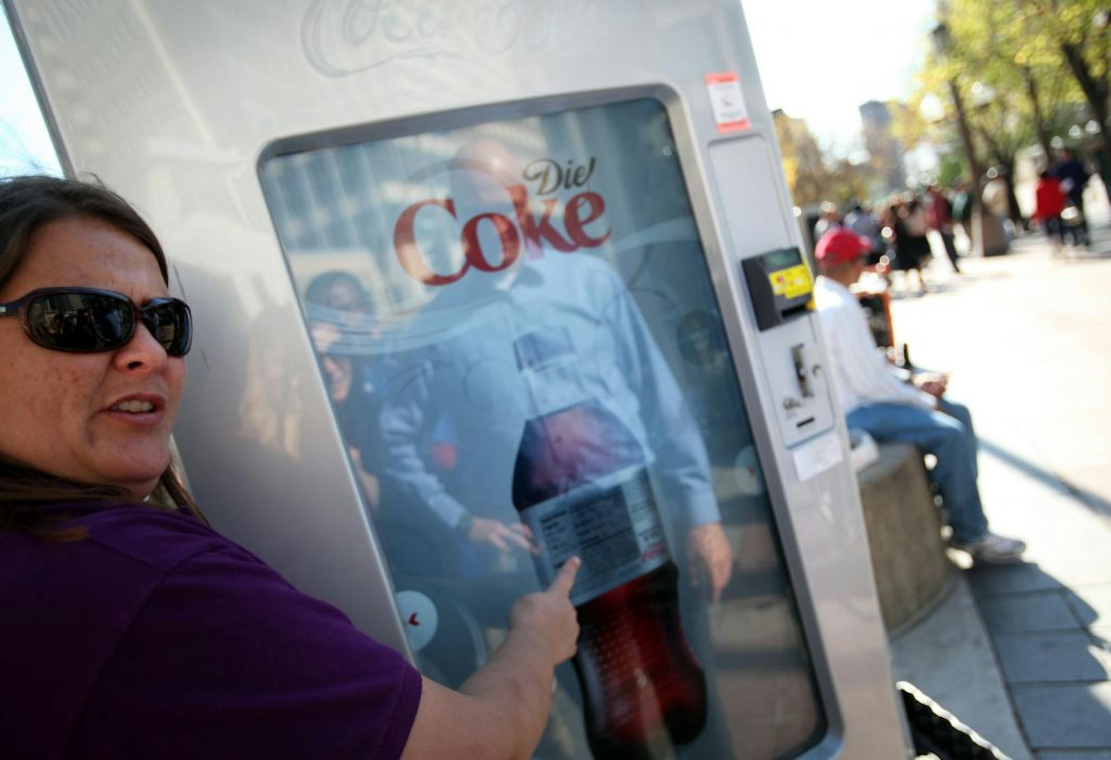Sandy Voight demonstrated how to spin a bottle to see nutritional info on a touch screen Coca-Cola vending machine at the Gratitude Tour, a up and coming vending machine showcase, at Peavey Plaza in Minneapolis, Minn., Tuesday, October 11, 2011.