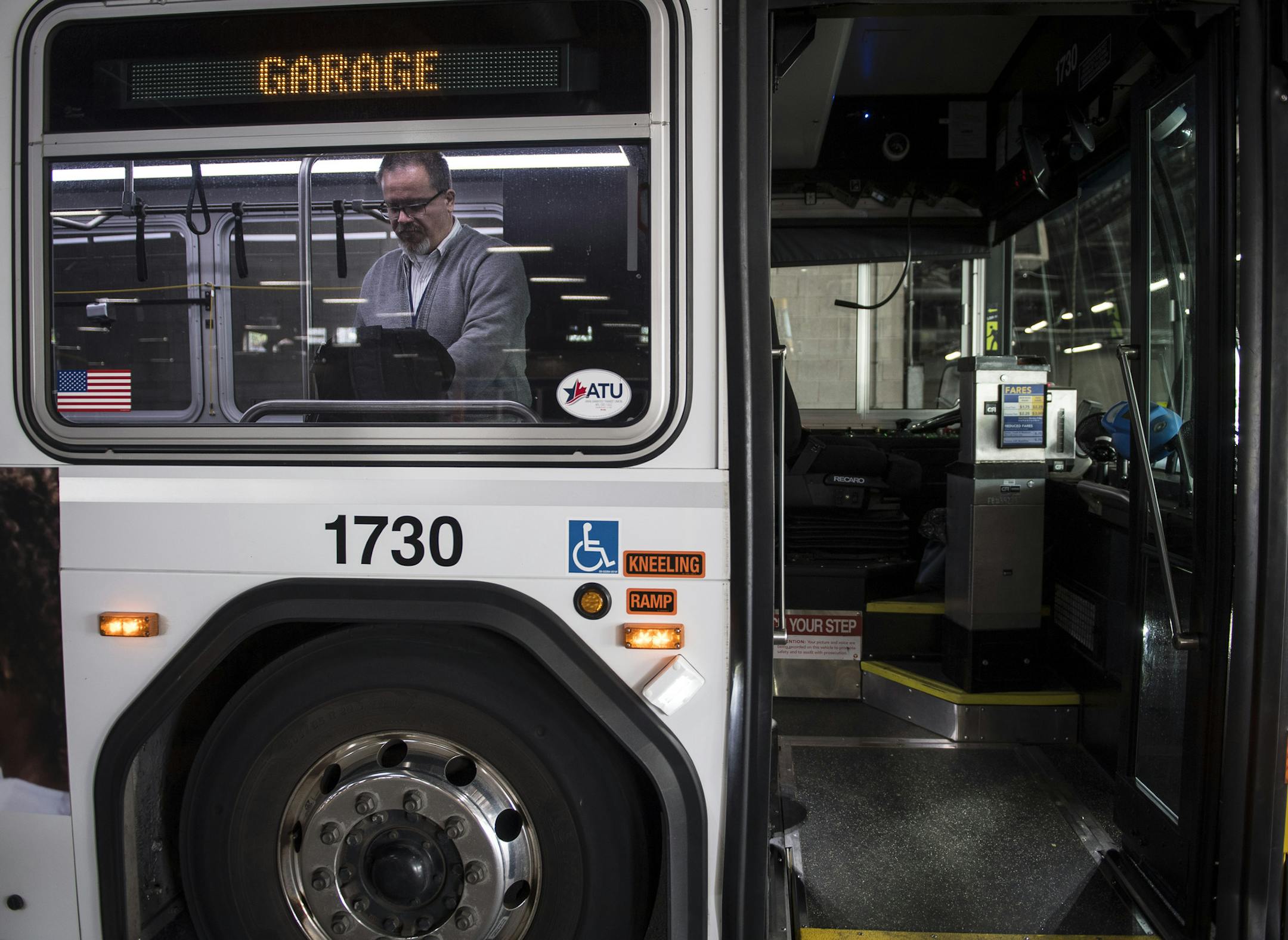 New Metro Transit bus driver James Hitz grabbed a few personal belongings from his backpack shortly before departing on his afternoon route Thursday afternoon from the garage at Nicollet and 32nd Street. ] (AARON LAVINSKY/STAR TRIBUNE) aaron.lavinsky@startribune.com We photograph new Metro Transit bus driver James Hitz, of Apple Valley, as he picked up and dropped off commuters along route 17F in Minneapolis on Thursday, May 19, 2016. "It's the best decision I've ever made," said Hitz of his dec