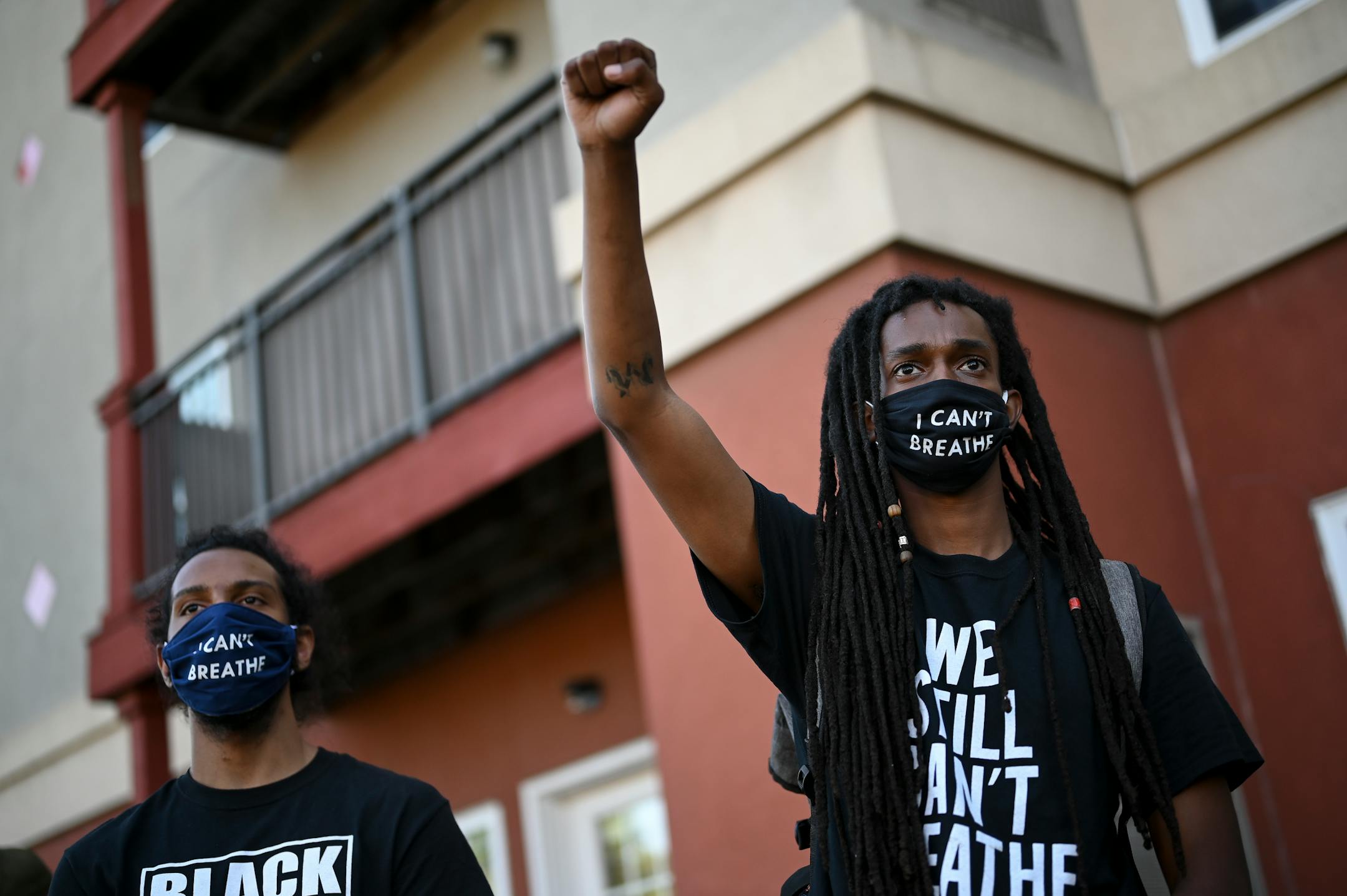 Robbie Tesfa, right, of Brooklyn Park, raised his fist in the air during Friday's rally outside the Minneapolis Police Union headquarters. Tesfa says his family fled civil war in Ethiopia and he's out protesting to make sure his future children won't have to endure conflict here. ]
aaron.lavinsky@startribune.com Protesters took part in a "Bob KKKroll Must Go!" rally against the Minneapolis Police Union and its president outside the union headquarters on Friday, June 12, 2020 in MInneapolis, Minn