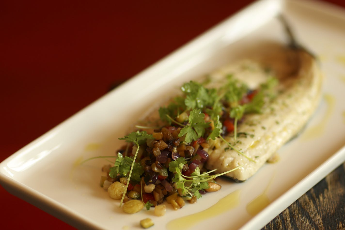Terzo Vino Bar is the new wine bar and restaurant from the Broder family empire at 50th and Penn in south Minneapolis. Broiled whole mediterranean branzino & summer caponata - zucchini, eggplant, fennel, red onion, golden raisins & pine nuts, as prepared at Terzo Vino Bar Thursday evening, September 19, 2013 in Minneapolis. ] JEFF WHEELER &#x201a;&#xc4;&#xa2; jeff.wheeler@startribune.com