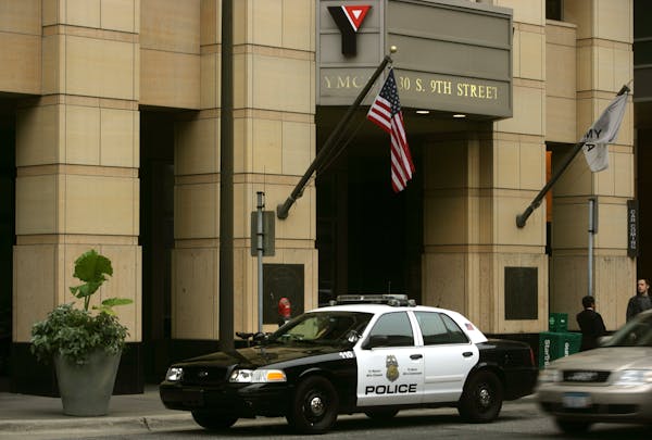 In this 2010 file photo, a police car sits outside the YMCA in downtown Minneapolis after David Smith was restrained by police and later died.