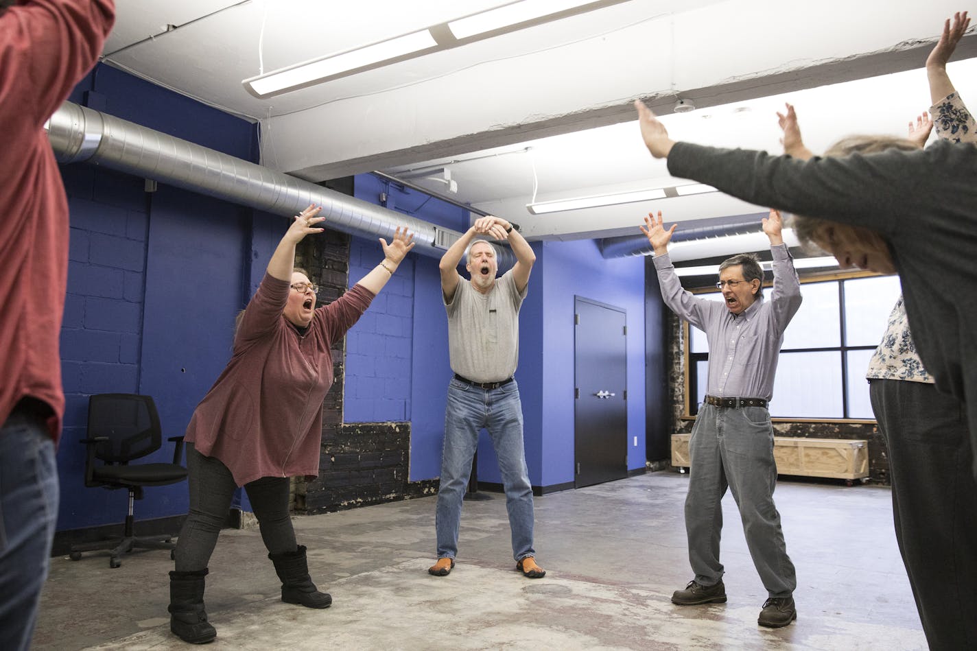 Improv instructor Lauren Anderson, left, led the class in warmups with students Jim Beggs, 71, and Scott Schumack, 66, at Brave New Workshop in downtown Minneapolis.