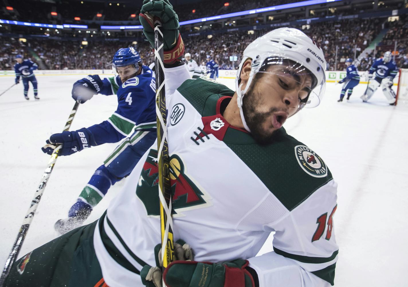 The Wild's Jordan Greenway, front, was tripped by Vancouver Canucks' Michael Del Zotto during the first period Tuesday. Greenway's physical force in the offensive zone helped the Wild find a rhythm.