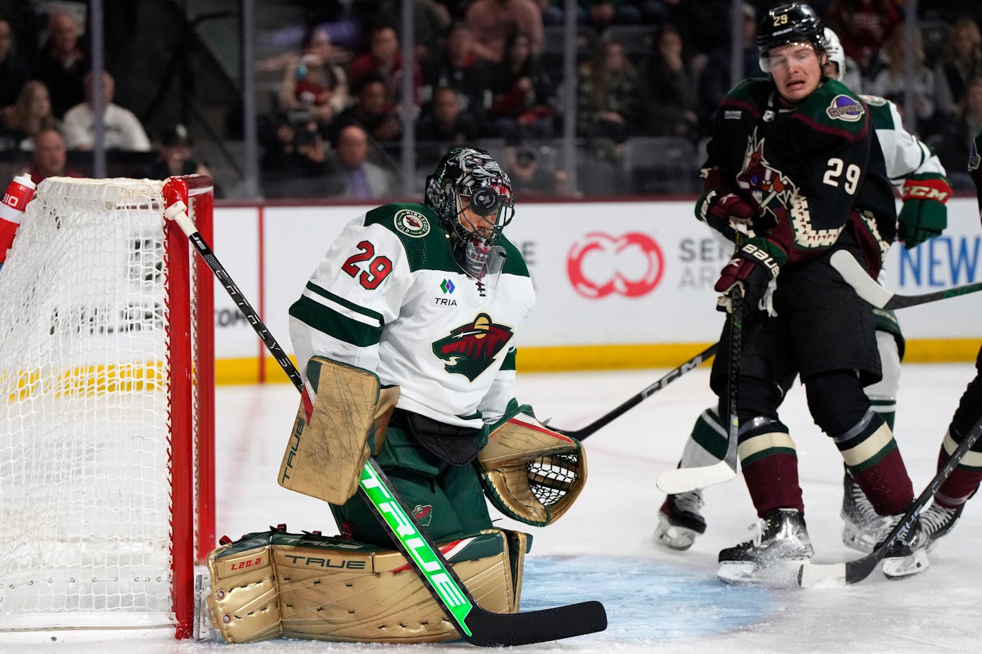 Minnesota Wild goaltender Marc-Andre Fleury (29) makes the save on Arizona Coyotes center Barrett Hayton in the first period during an NHL hockey game, Monday, Feb. 6, 2023, in Tempe, Ariz. (AP Photo/Rick Scuteri)