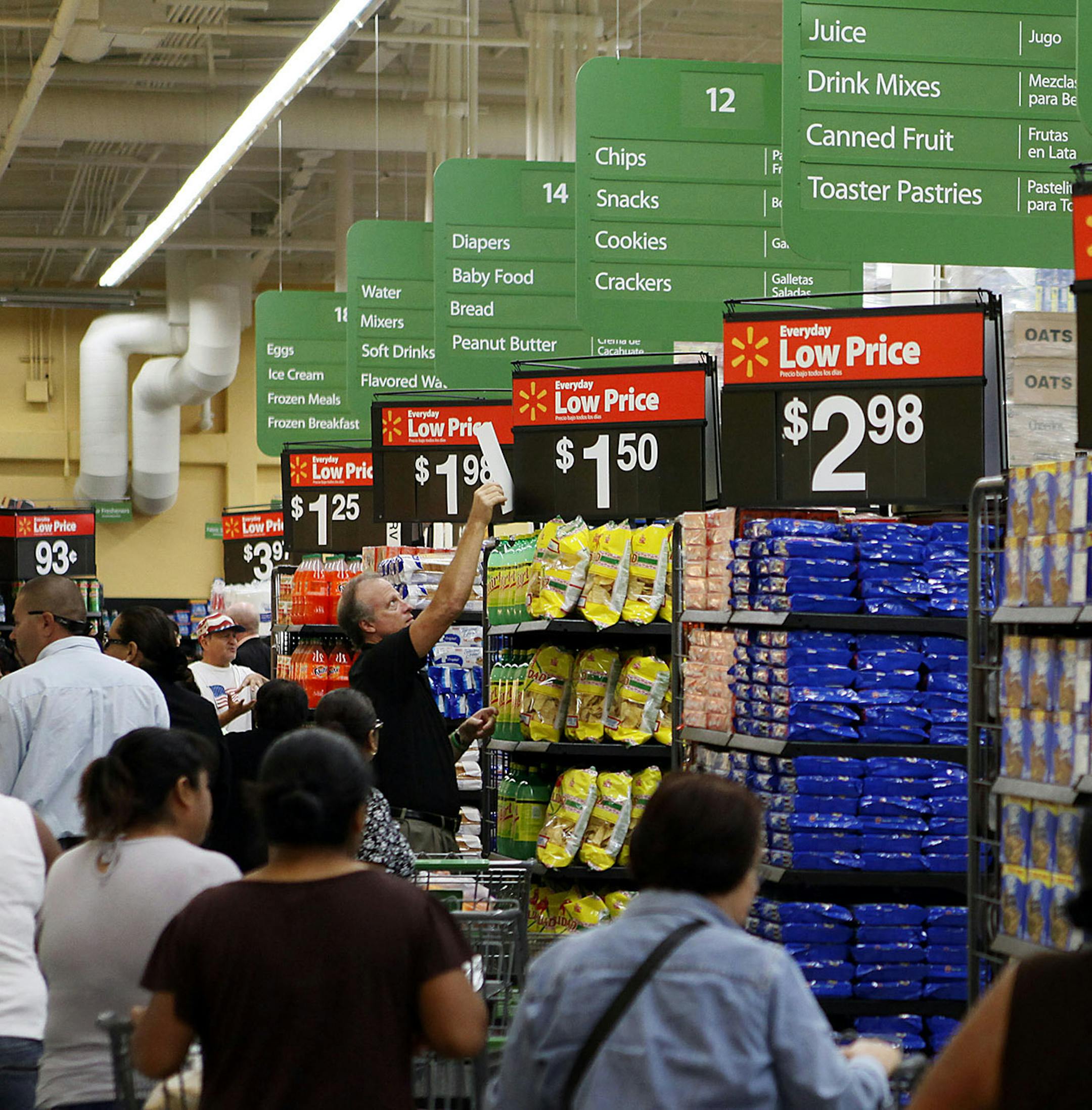 Customers shop during the grand opening of a Wal-Mart Stores Inc. location in Panorama City, California, U.S., on Friday, Sept. 28, 2012. Wal-Mart Stores Inc., the world‚Äôs largest retailer, will hire more than 50,000 temporary workers in its U.S. stores for the holiday shopping season. Photographer: Patrick T. Fallon/Bloomberg ORG XMIT: 153143139