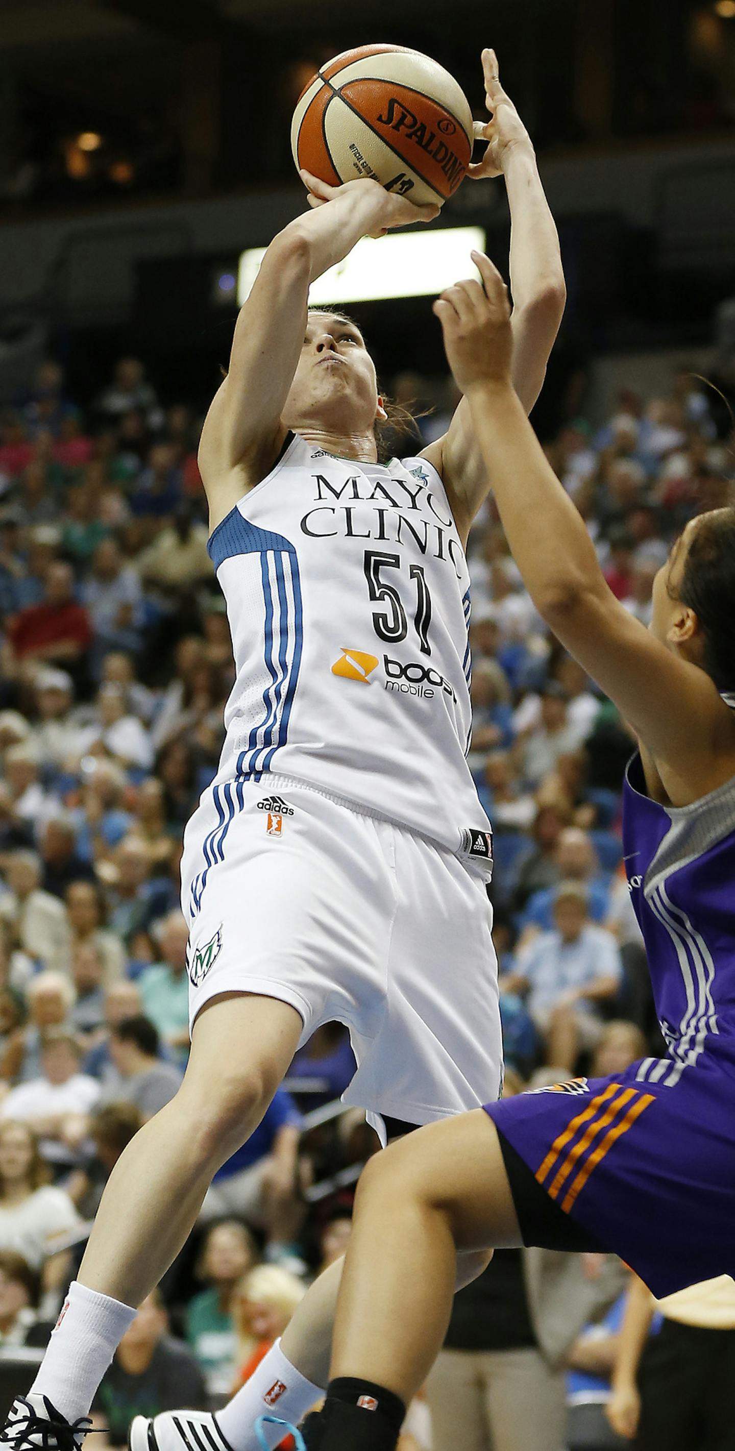 Minnesota Lynx guard Anna Cruz (51) shoots against Phoenix Mercury guard Leilani Mitchell (5) during the first half of a WNBA basketball game, Sunday, Aug. 30, 2015, in Minneapolis. (AP Photo/Stacy Bengs)