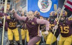 Minnesota head coach P J. Fleck leads his team onto the field before action against Illinois at TCF Bank Stadium in Minneapolis on Saturday, Oct. 21, 