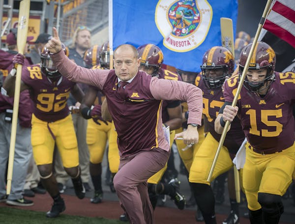 Minnesota head coach P J. Fleck leads his team onto the field before action against Illinois at TCF Bank Stadium in Minneapolis on Saturday, Oct. 21, 