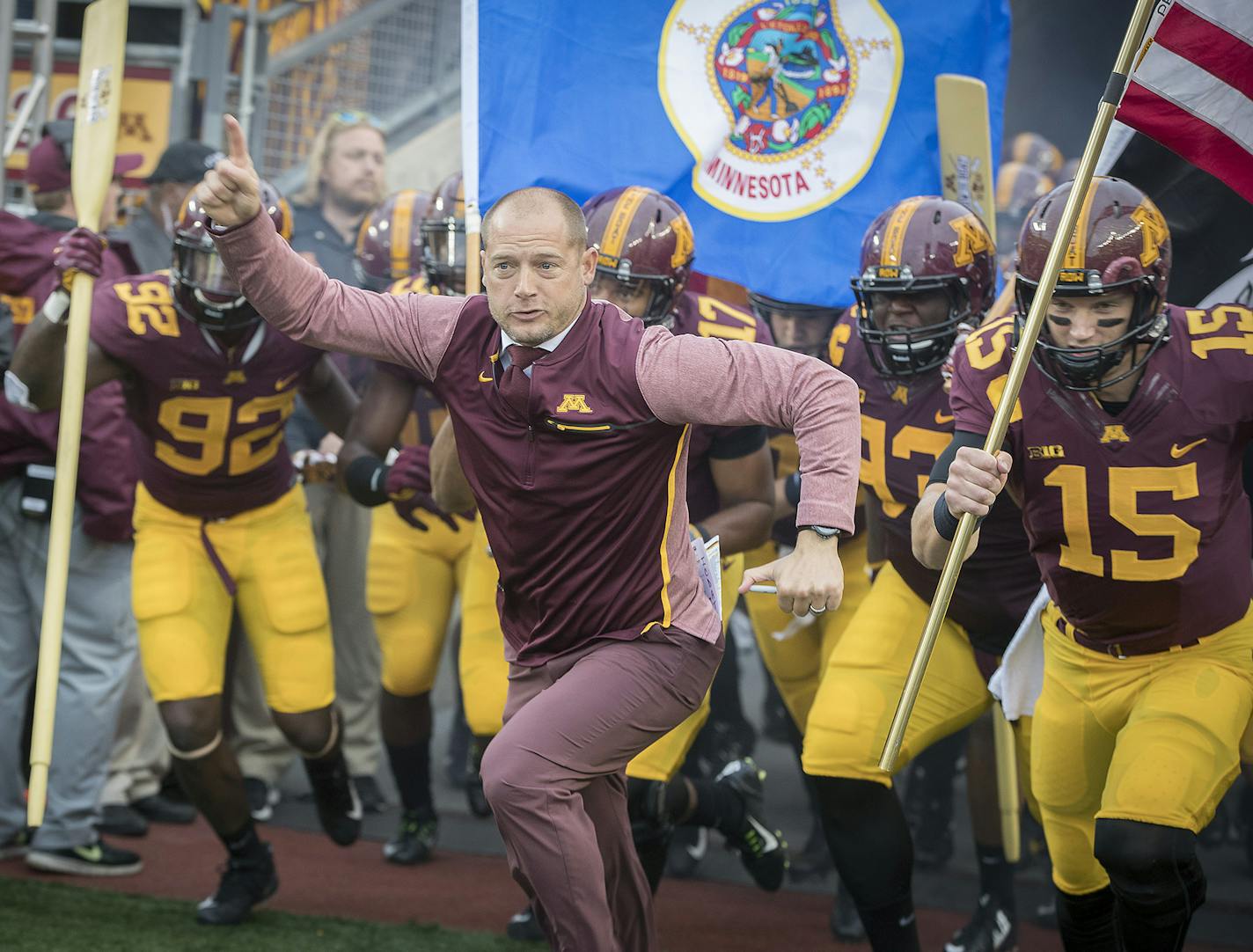 Minnesota head coach P J. Fleck leads his team onto the field before action against Illinois at TCF Bank Stadium in Minneapolis on Saturday, Oct. 21, 2017. The host Golden Gophers won, 24-17. (Elizabeth Flores/Minneapolis Star Tribune/TNS) ORG XMIT: 1213861