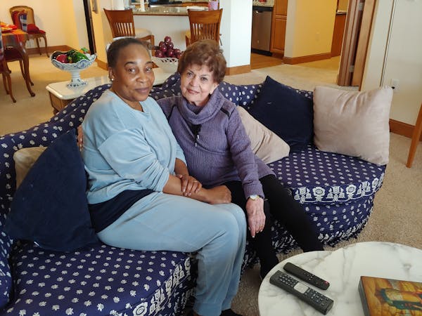 Caregiver Vickey Korlewala, left, with Gretta Freeman.