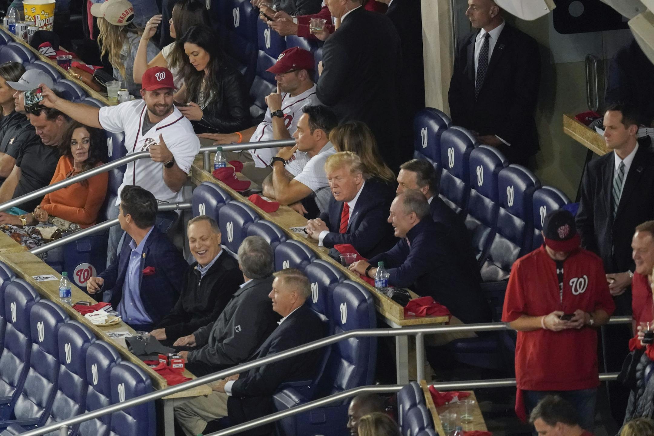 President Donald Trump, center seated, talks with other Republican lawmakers during Game 5 of baseball World Series between the Houston Astros and Washington Nationals, Sunday, Oct. 27, 2019, at Nationals Park in Washington. (AP Photo/Pablo Martinez Monsivais)