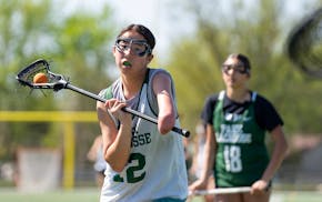 Hollen Thompson, a senior defender on Park High's girls lacrosse team, practices with her team at Park High School in Cottage Grove, Tuesday, May 6, 2
