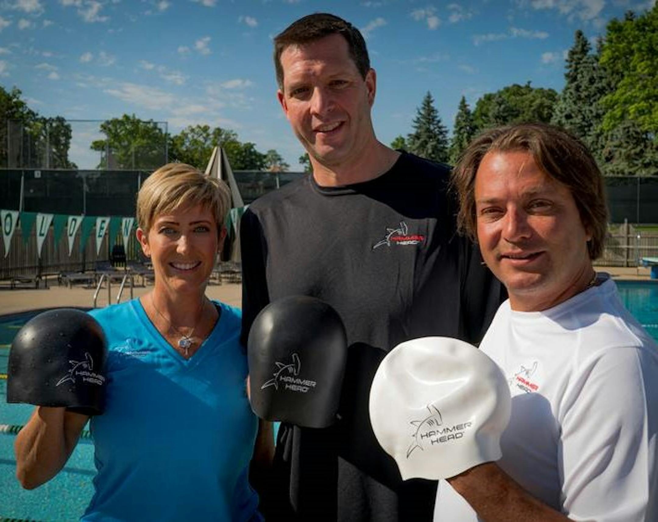 LEFT TO RIGHT: Theresa Finn, CEO of Mako International LLC; US Olympian Tom Malchow and Mako COO David Burns. THey are posing with the Hammer Head Swim Cap.