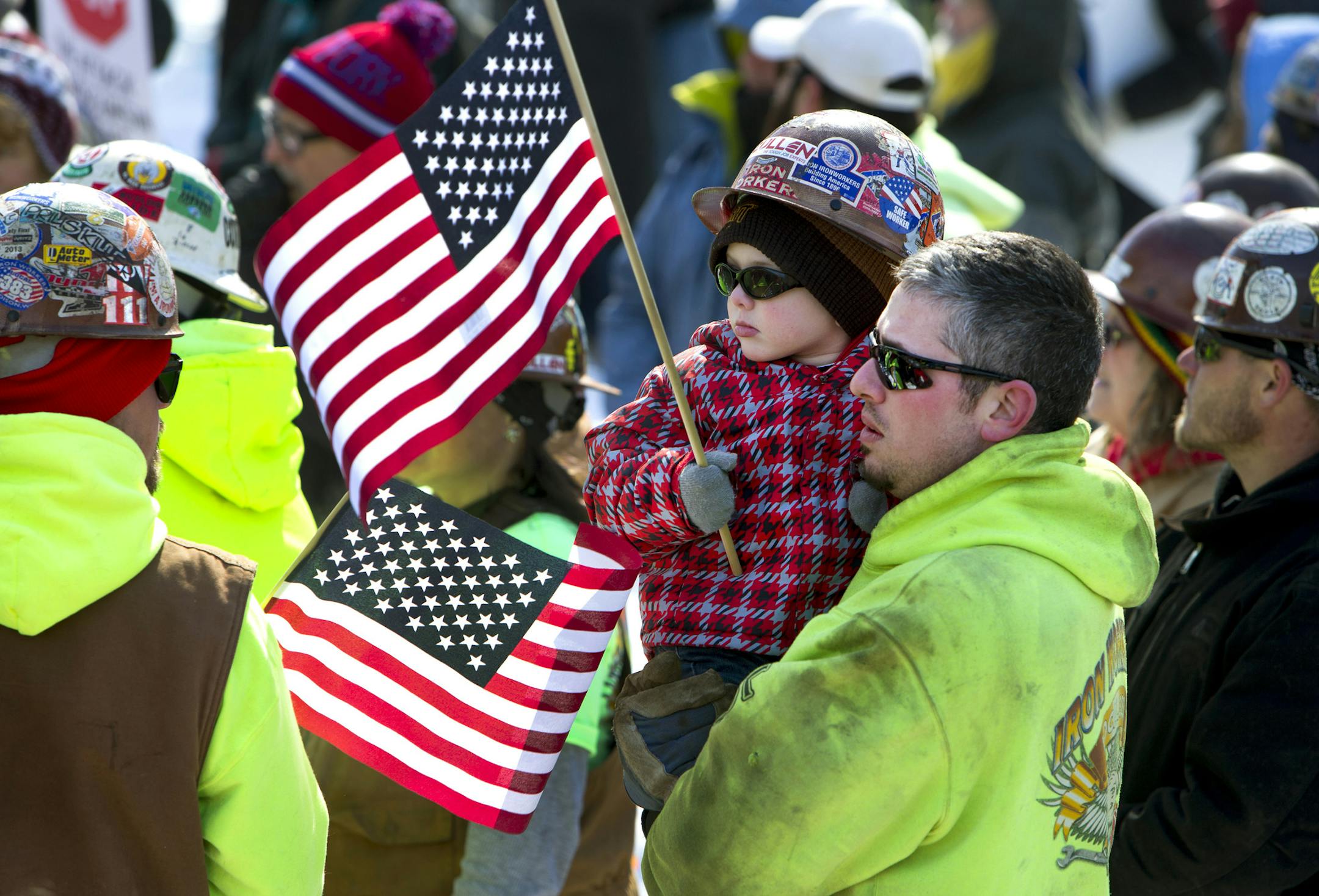 Todd Groom, of Prairie du Chien, Wis., and his son Haydan Groom, 4 participate in a rally against a "right-to-work" proposal, on Saturday, Feb. 28, 2015, in Madison, Wis. Thousands of Wisconsin union workers rallied at the Capitol Saturday to protest a "right-to-work" proposal that would outlaw the mandatory payment of union dues, but the crowd was much smaller than those in 2011 against Gov. Scott Walker's law stripping public sector unions of much of their power. Groom is a member of Iron Work