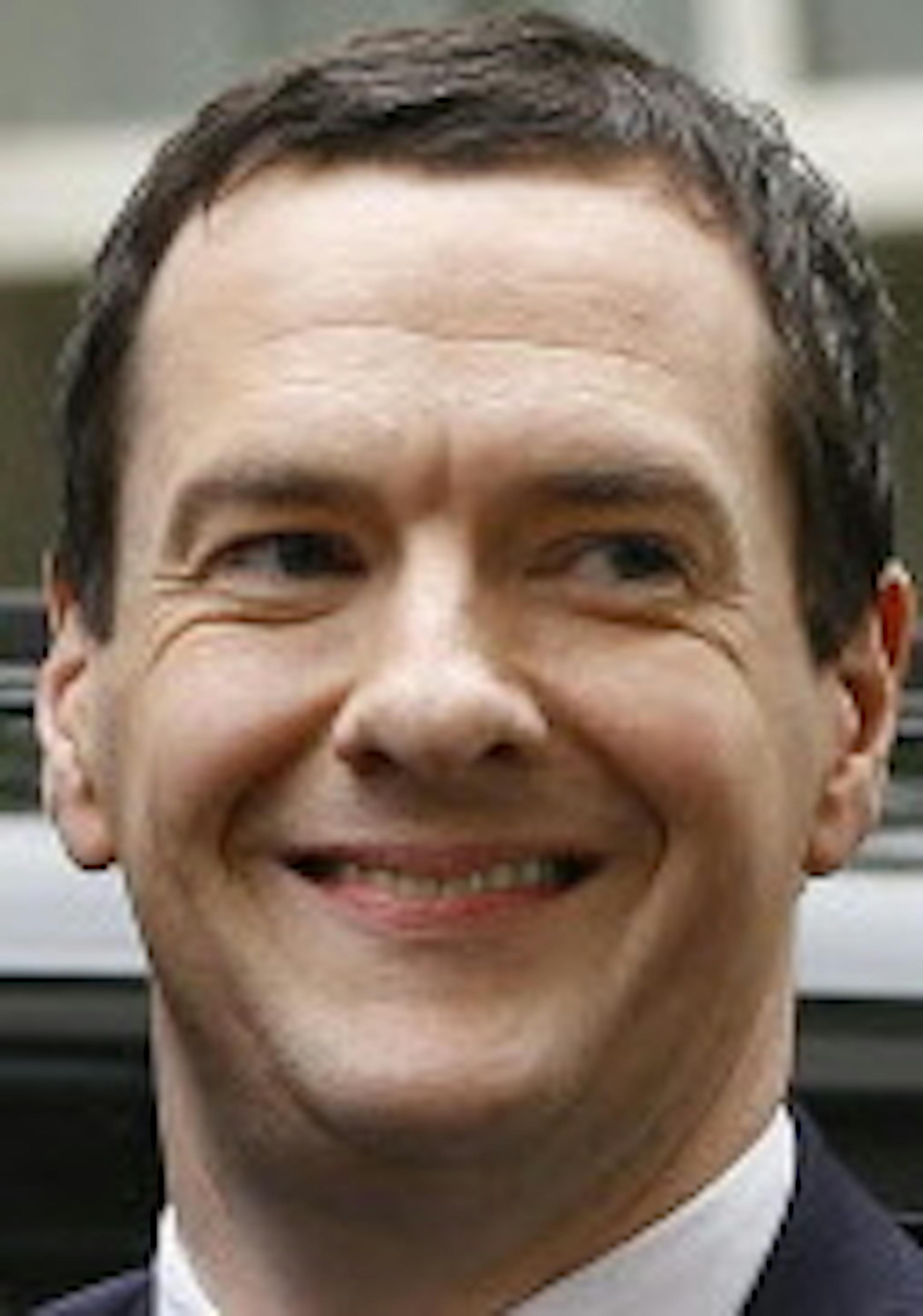 Britain's Chancellor George Osborne smiles as he arrives in Downing Street in London, Friday, May 8, 2015. The Conservative Party surged to a surprisingly commanding lead in Britain's parliamentary election, with returns Friday backing an exit poll's prediction that Prime Minister David Cameron would remain in 10 Downing Street. (AP Photo/Kirsty Wigglesworth)