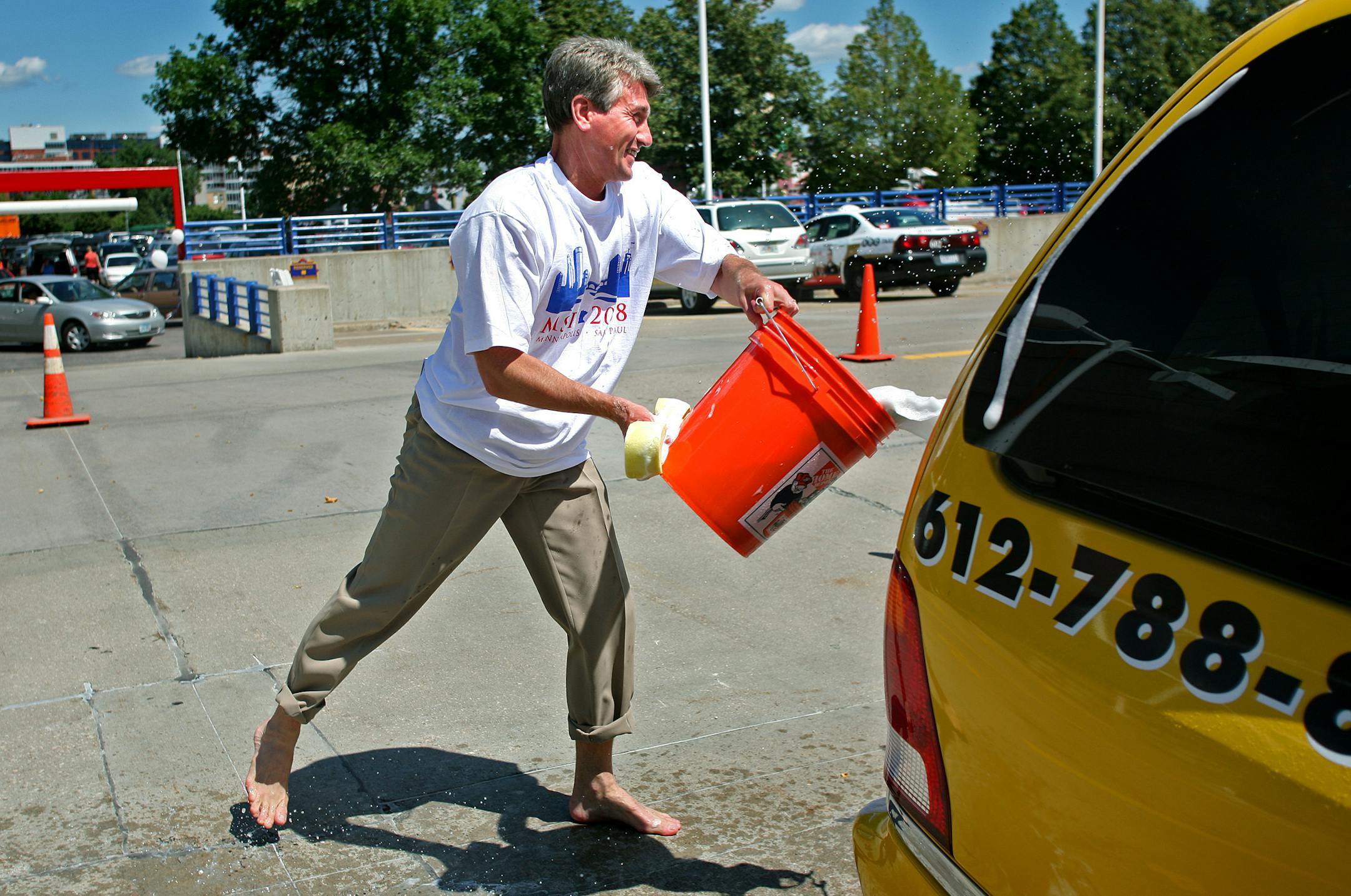 Minneapolis Mayor R.T. Rybak threw a bucket of soapy water in the direction of Bloomington Mayor Gene Winstead on Tuesday during a free taxi wash at the Metrodome parking lot. The event, sponsored by the Minneapolis St. Paul Host Committee, was intended to help cabdrivers spruce up their vehicles in preparation for the Republican National Convention.