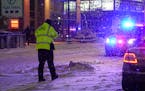 Officials investigate the scene where a pedestrian was struck and killed by a car on Hennepin Avenue near 8th Street in Minneapolis on Tuesday, Februa
