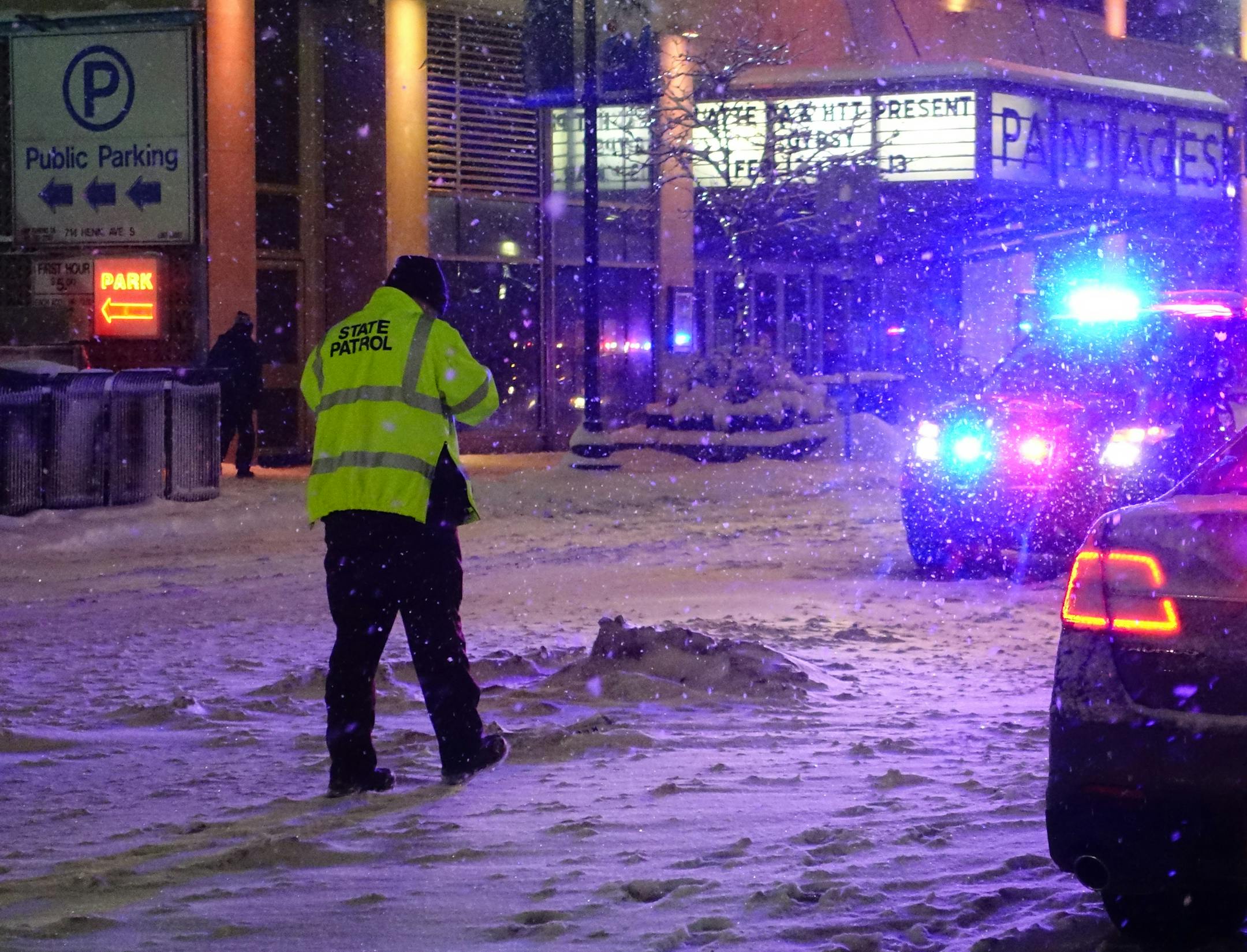 Officials investigate the scene where a pedestrian was struck and killed by a car on Hennepin Avenue near 8th Street in Minneapolis on Tuesday, February 2. The pedestrian was in the crosswalk when she was struck and was dragged down Hennepin Ave. The woman later died from the injuries. ] (SHARI L. GROSS/STAR TRIBUNE) SHARI L. GROSS ï sgross@startribune.com