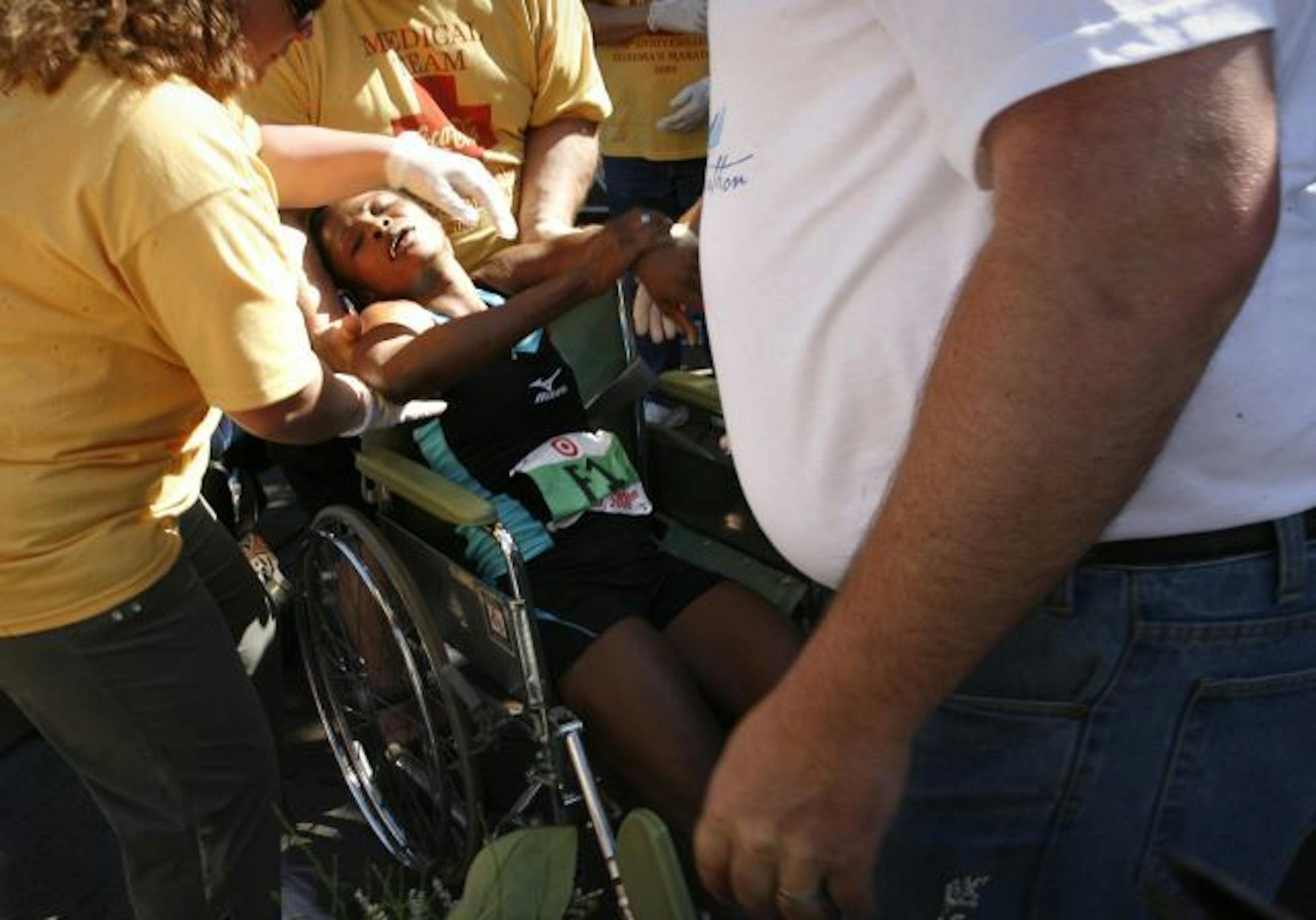 Female winner Mary Akor collapses and is put into a wheelchair soon after crossing the finish line at Grandma's Marathon in Duluth.