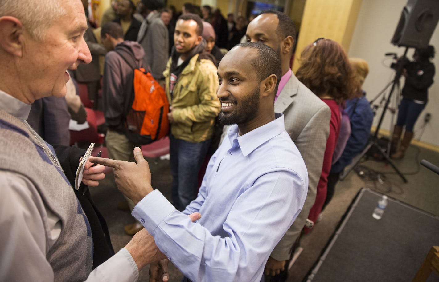 Hassan Yussuf, left, a local Somali-American who ran for school board and lost in St. Cloud in 2014, talks with Crosier Father Virgil Petermeier of the Crosier Community of Onamia after Yussuf participated in a forum discussion entitled "Muslims in Minnesota: A community conversation" held by Minnesota Public Radio at St. Cloud Library on Thursday, January 28, 2016. ] (Leila Navidi/Star Tribune) leila.navidi@startribune.com