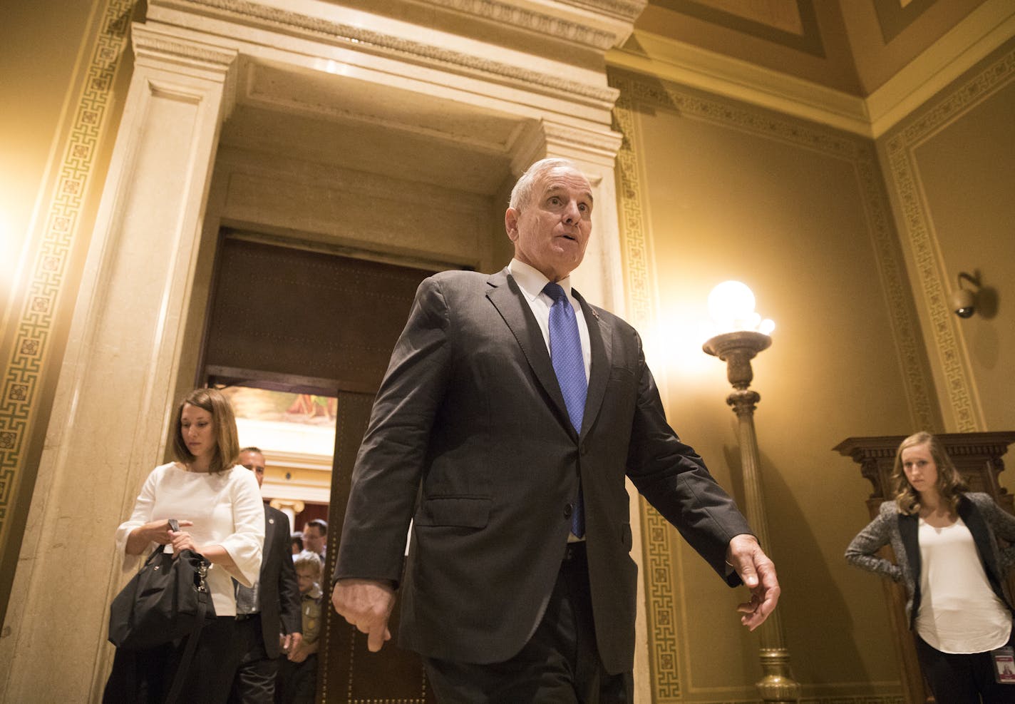 Gov. Mark Dayton walks out of the courtroom in the Capitol after oral arguments concluded.