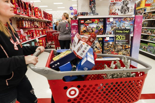 Shoppers browse the aisles during a Black Friday sale at a Target store in Newport, Ky., in 2018. (AP Photo/John Minchillo)