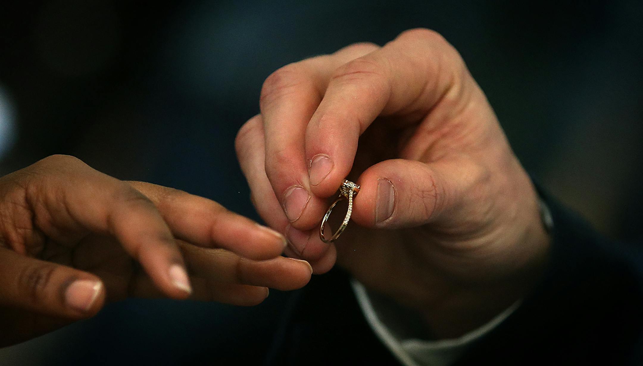 Pat Dalton placed a wedding ring on the finger of bride Julie Gicheru. ] JIM GEHRZ ï james.gehrz@startribune.com / Minneapolis, MN / February 12, 2016 /12:00 PM ñ BACKGROUND INFORMATION : Fourth Judicial District judges will unite 34 couples in matrimony at no charge on Friday, February 12, 2016. More than 100 couples have been united at the Valentineís Day weekend annual event. A quartet, Musica Ipsa Loquitor, featuring the Honorable Elizabeth Cutter will play throughout the marr