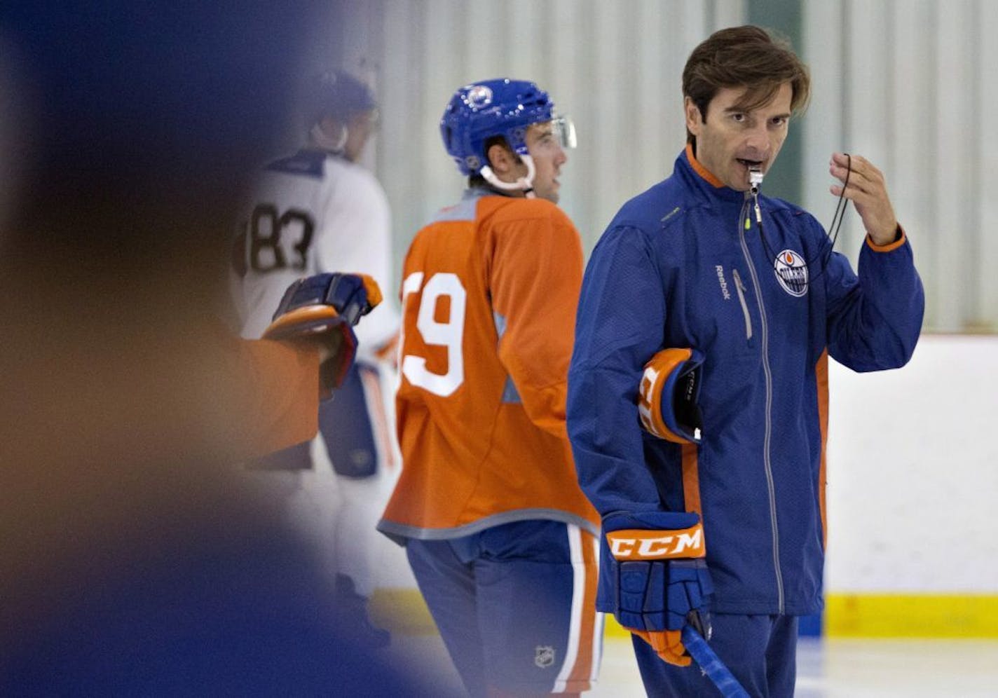 Edmonton Oilers coach Dallas Eakins directs the drills during the NHL hockey team's training camp in Sherwood Park, Alberta, on Thursday, Sept. 12, 2013.