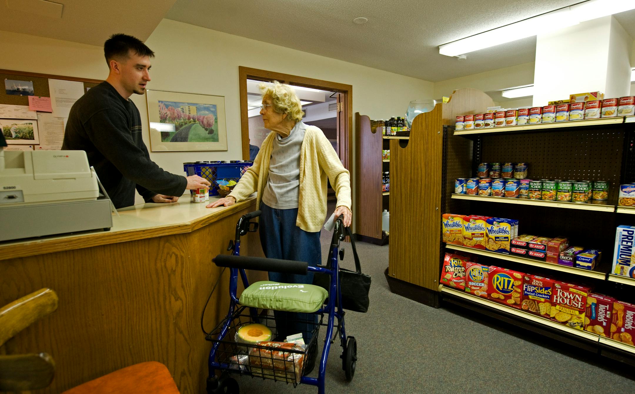 Julia Hildebrandet does some of her grocery shopping at the convienience store at 7500 York. Benjamin Nelson is the clerk.