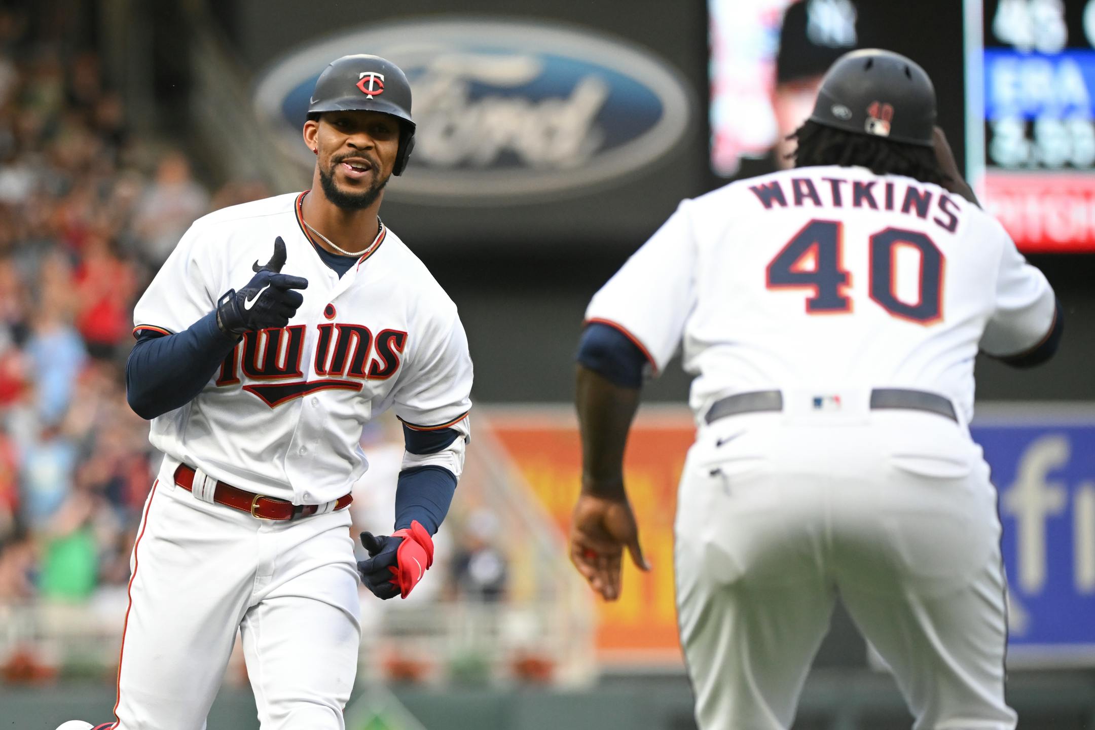 Minnesota Twins center fielder Byron Buxton (25) gestures to third base coach Tommy Watkins (40) as Buxton rounds the bases following a 3-run home run hit against the New York Yankees in the bottom of the second inning.