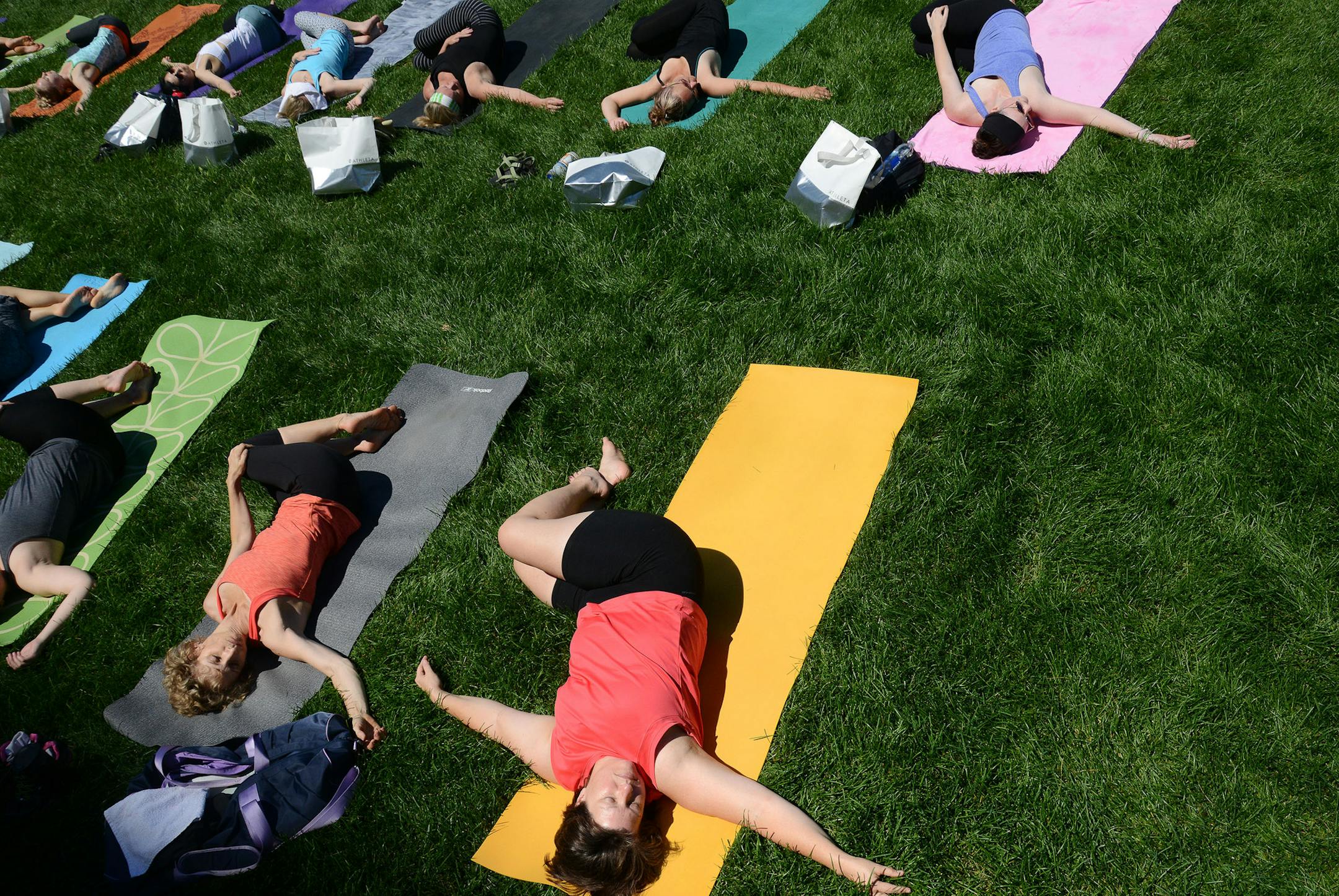 People stretched out during Yoga Camp's free outdoor yoga event on International Yoga Day in Minneapolis, Minn., on Sunday June 21, 2015. Yoga Camp is new this year, and continues from the summer solstice to the autumn equinox. ] RACHEL WOOLF &#x2211; rachel.woolf@startribune.com