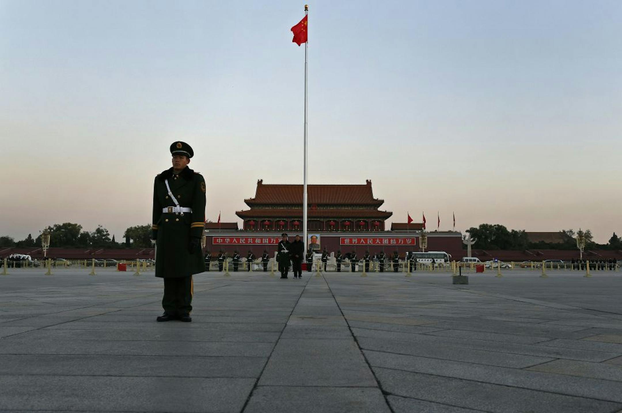 A Chinese paramilitary policeman stands guard at a flag raising ceremony.