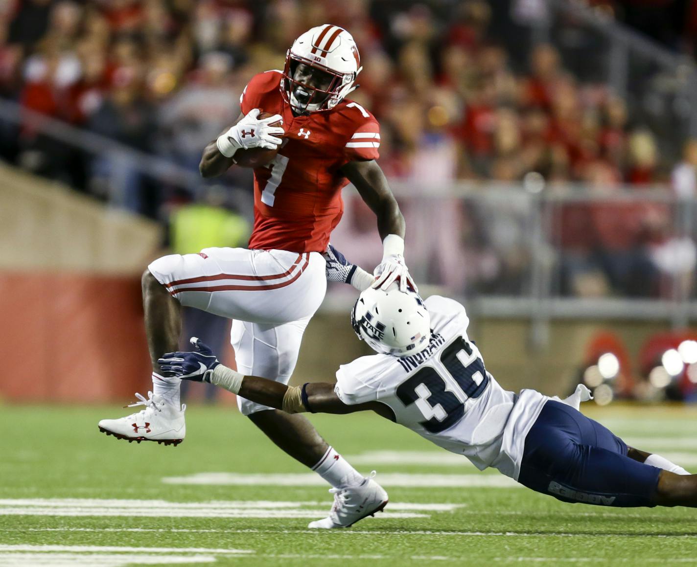 FILE - In this Sept. 1, 2017, file photo, Wisconsin running back Bradrick Shaw runs past Utah State's Ja'Marcus Ingram during the second half of an NCAA college football game in Madison, Wis. Wisconsin freshman Jonathan Taylor is listed as questionable for Saturday's game at Indiana, with an injured left leg. If his workload is reduced or he can&#xed;t play, the Badgers are likely to look to former starter Shaw and redshirt freshman Garrett Groshek to fill in. (AP Photo/Andy Manis, File)