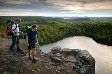 FILE-Father and son hikers, Tom and Ross Perigo enjoyed the evening view high above Bean Lake on the Superior Hiking Trail.