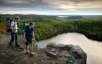 FILE-Father and son hikers, Tom and Ross Perigo enjoyed the evening view high above Bean Lake on the Superior Hiking Trail.
