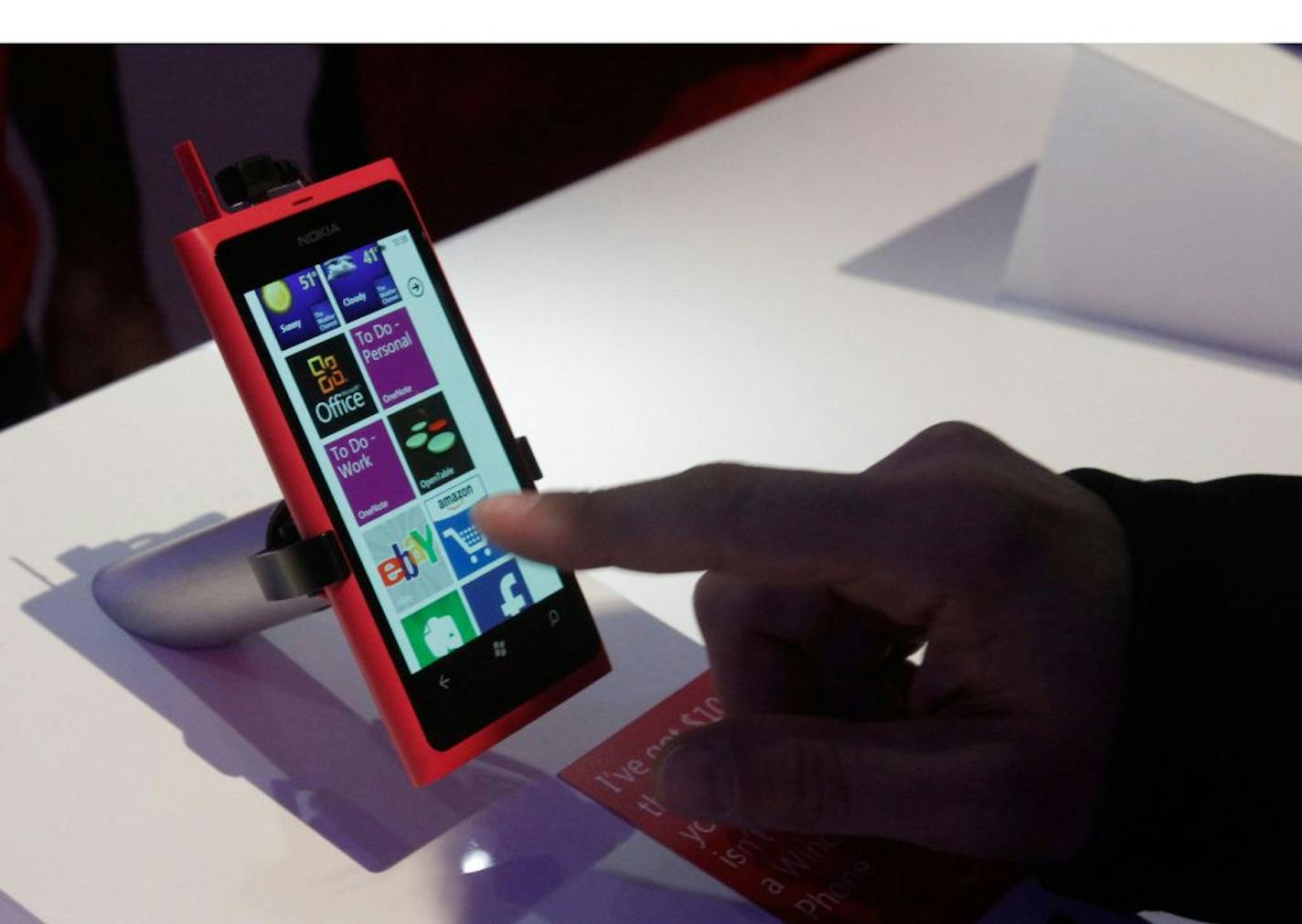 A CES attendee tests out the Windows Phone app experience on the new Nokia Lumia 800 in the Microsoft booth at CES 2012 in Las Vegas, Nevada on January 10, 2012.