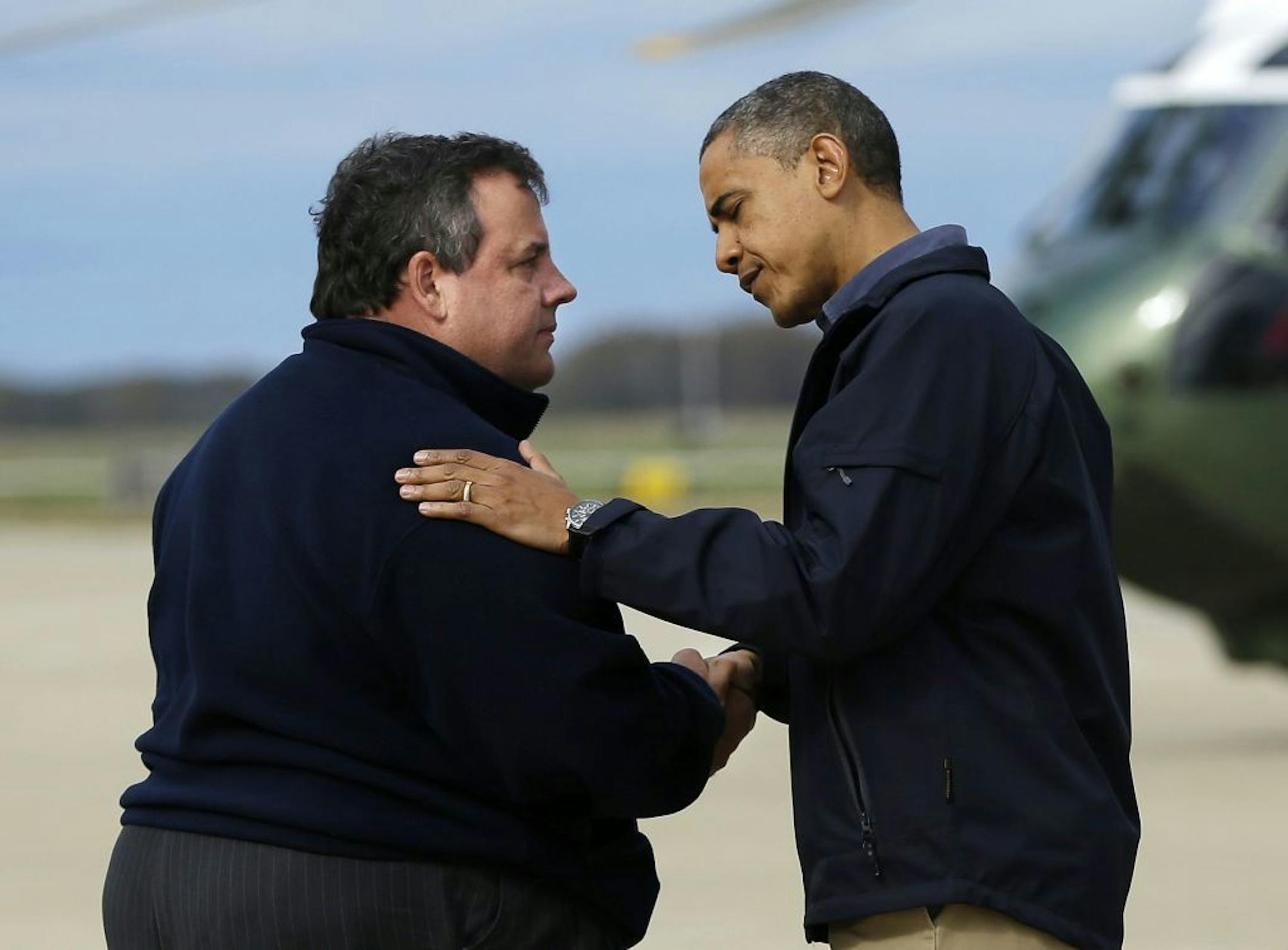 President Barack Obama is greeted by New Jersey Gov. Chris Christie upon his arrival at Atlantic City International Airport, Wednesday, Oct. 31, 2012, in Atlantic City, NJ. Obama traveled to region to take an aerial tour of the Atlantic Coast in New Jersey in areas damaged by superstorm Sandy,