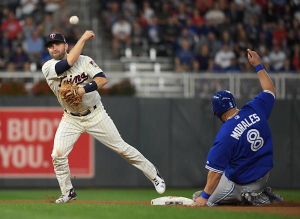 Blue Jays designated hitter Kendrys Morales was out at second as Twins second baseman Brian Dozier turned a double play.