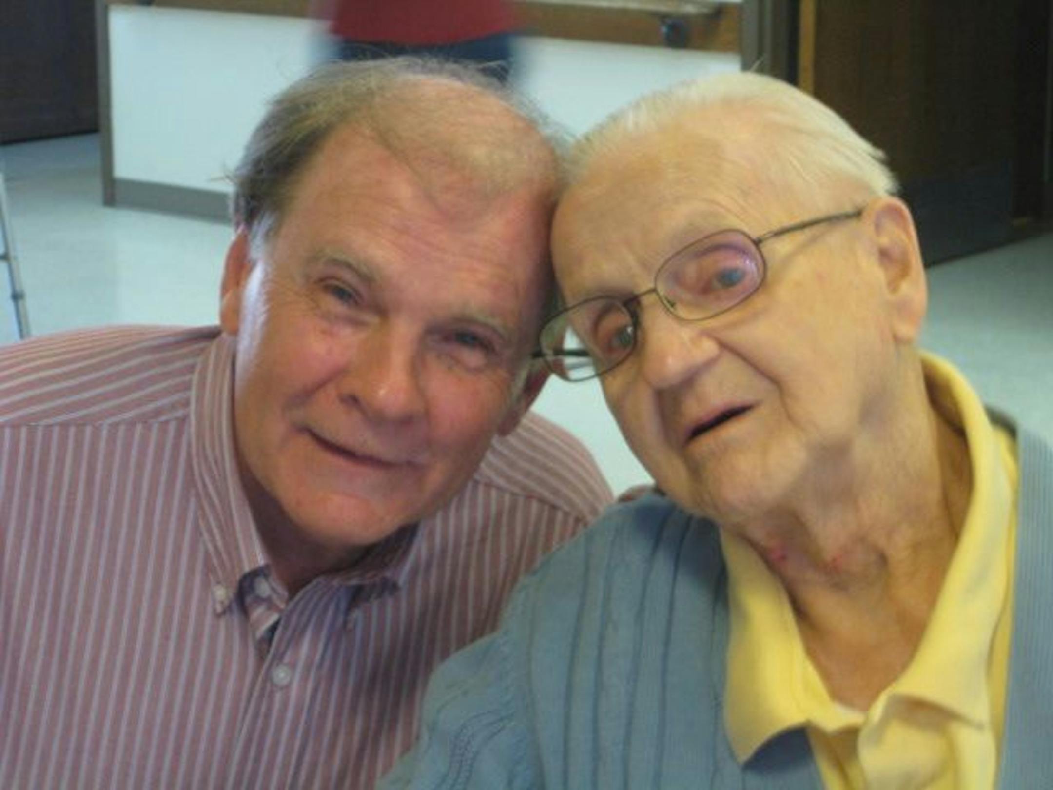 Loren Wolfe, left, visits with 90-year-old retired butcher John Havonetz after a recent gig at Friendship Manor in Shakopee.