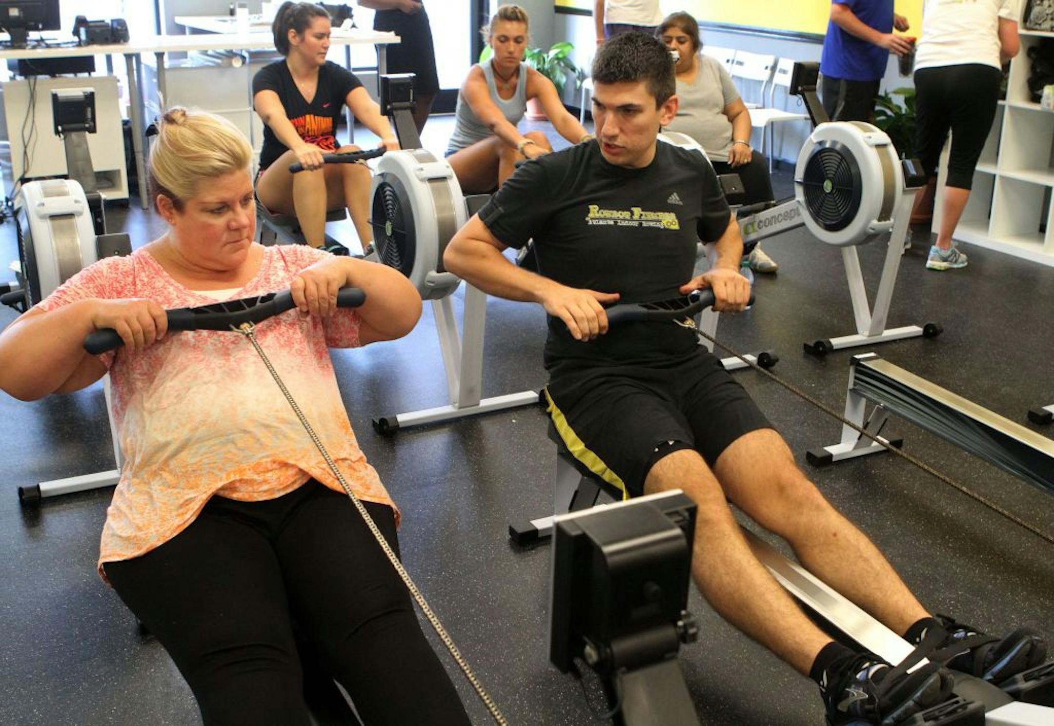 Debby Fritts got tips from Charles Anderson before an exercise class at his new Rowbot Fitness gym in Smyrna, Ga. Former college rower Anderson said every stroke uses leg, core and arm muscles.