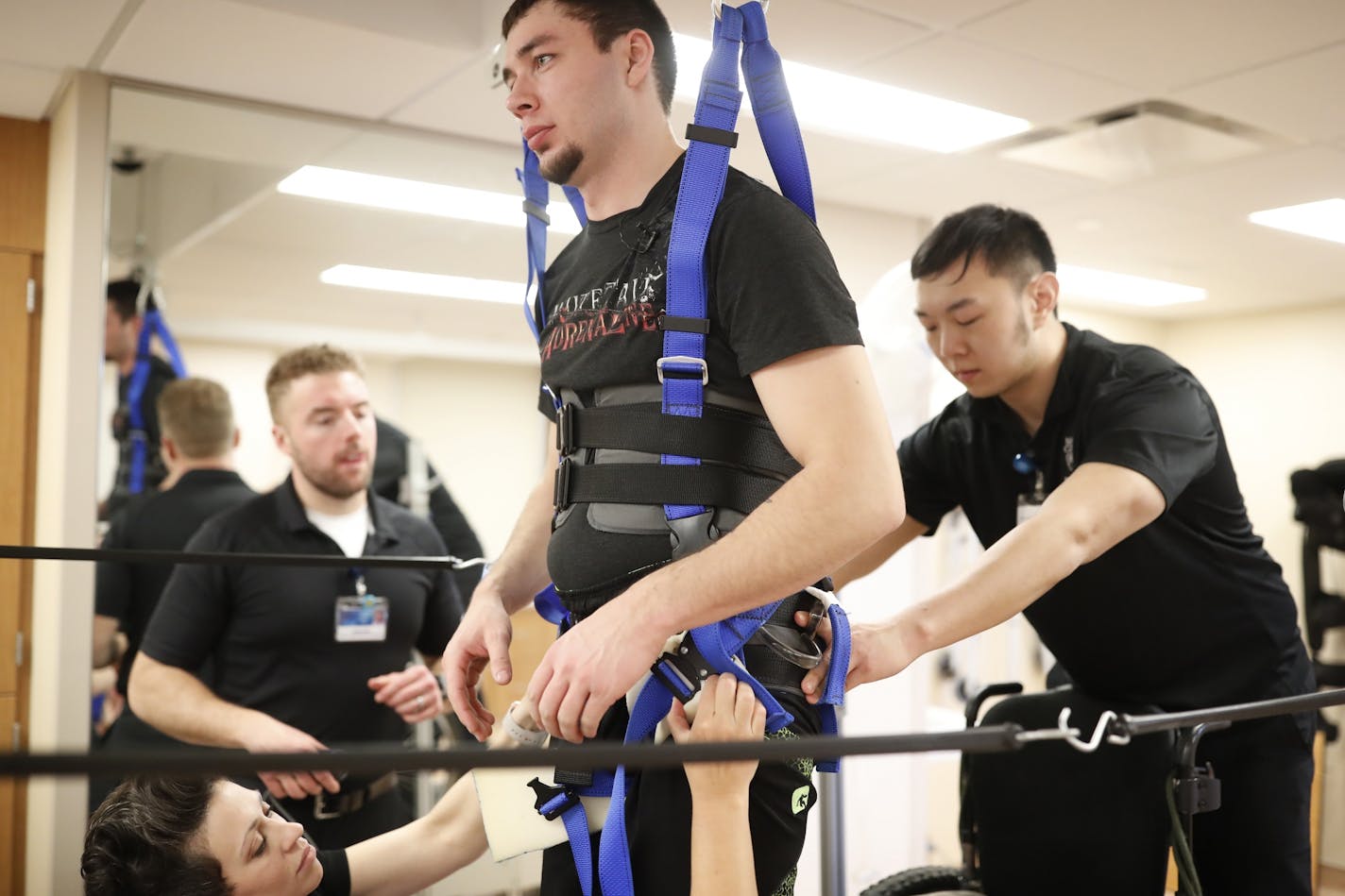 Therapist Margaux Linde left and Allen Li at the Mayo Clinic helped Jered Chinnock walk on a treadmill as he is recovering from a spinal cord injury. Jered is part of study that includes epidural stimulation for is injury at Mayo Clinic Hospital, Saint Mary�s Monday March 27, 2017 in Rochester, MN.