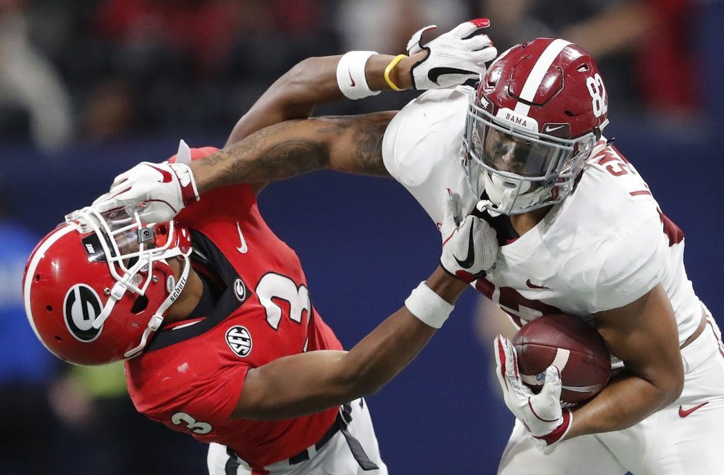 Alabama tight end Irv Smith Jr. (82), right, hits Georgia defensive back Tyson Campbell (3) in the helmet during the first half of the Southeastern Conference championship NCAA college football game, in Atlanta.