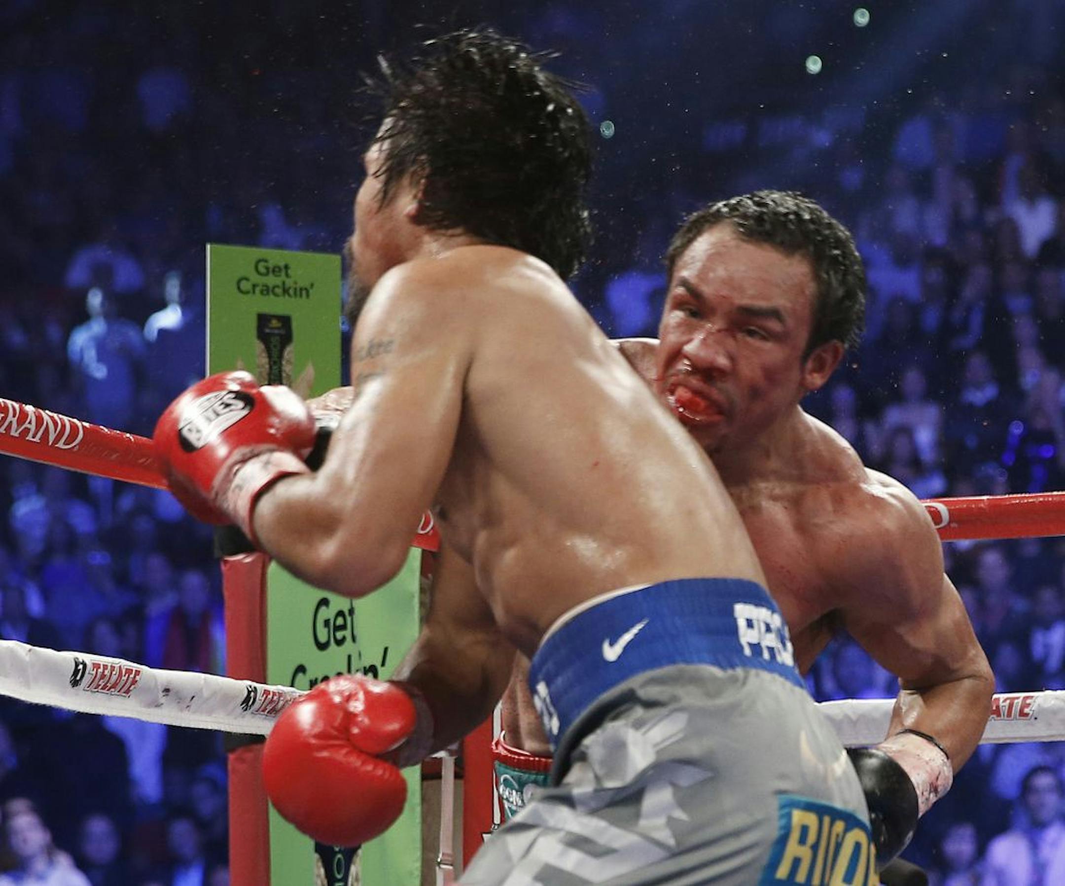 Juan Manuel Marquez, right, knocked out Manny Pacquiao in the sixth round of their world welterweight fight Saturday night in Las Vegas. It was the fourth meeting of the two, and Pacquiao had won the previous three.