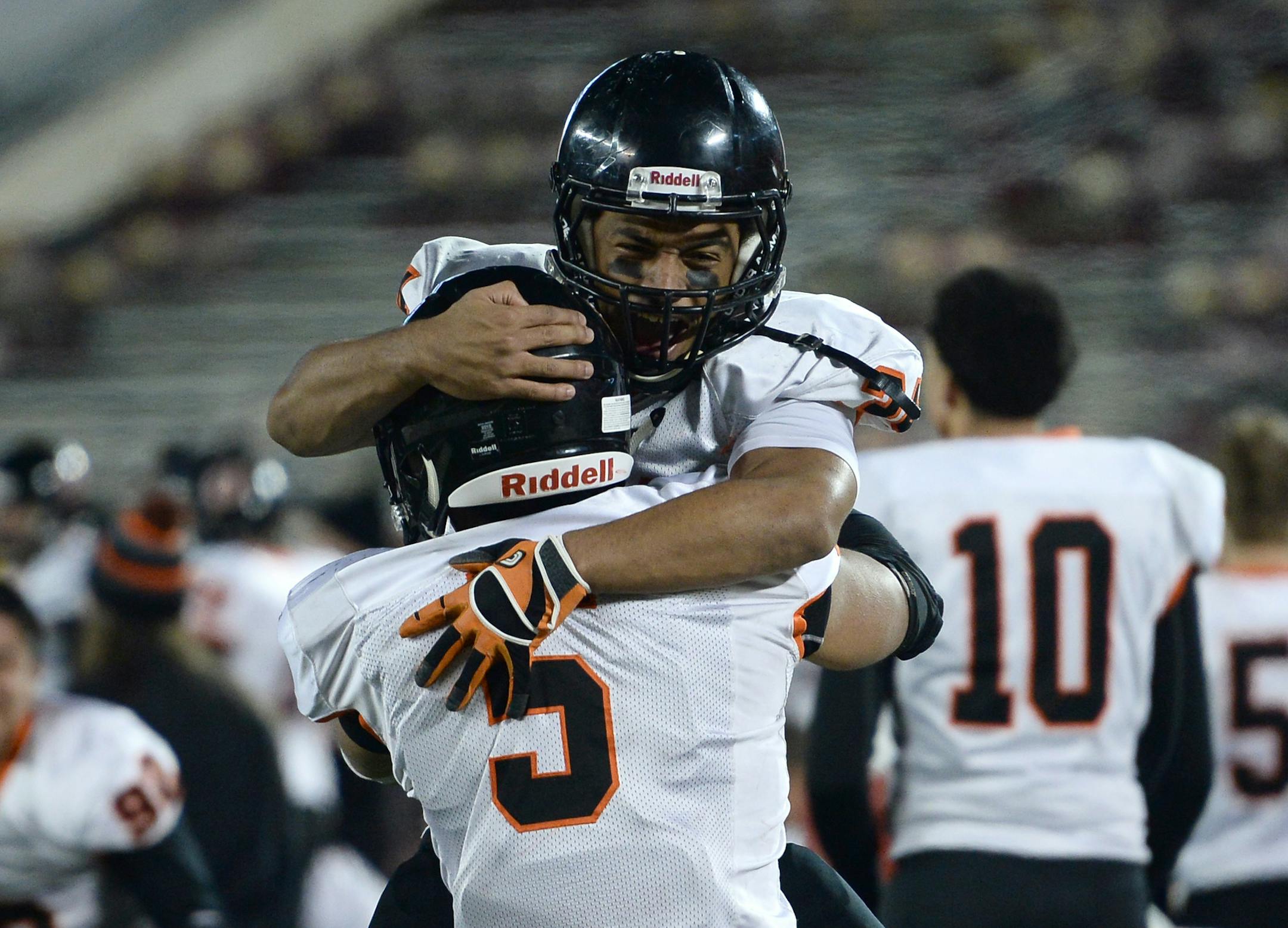 Osseo linebacker Vesean Mindestrom (34) and linebacker Kordell Russell (5) celebrated after defeating East Ridge in the 6A championship. ] (AARON LAVINSKY/STAR TRIBUNE) aaron.lavinsky@startribune.com Osseo played East Ridge in the Class 6A championship game on Friday, Nov. 13, 2015 at TCF Bank Stadium.