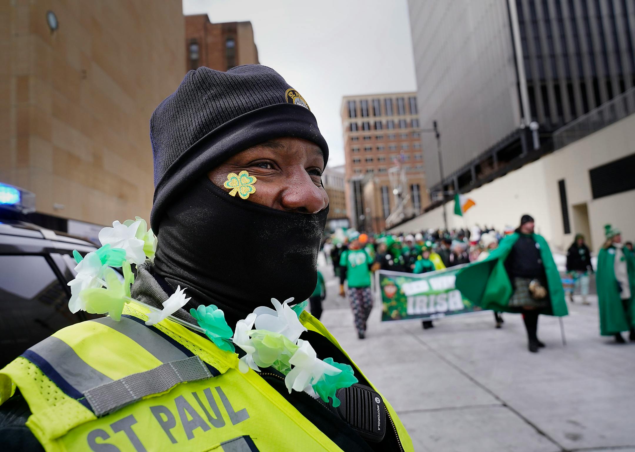 St. Paul Police Officer Tommy Adams wore a clover and some beads supplied by parade attendees.