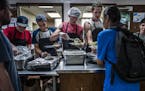 The diner hour is a busy time for volunteers. On the menu, Philly steak on a bun with a green salad and zucchini from the kitchen's gardens. ] Loaves 