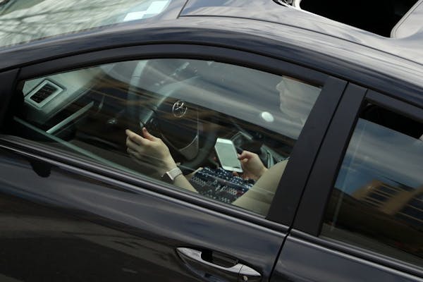 A woman used a cell phone while driving in downtown Minneapolis Wednesday.