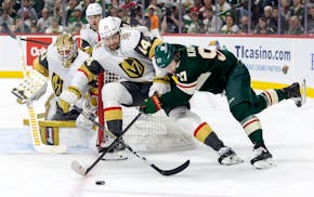 Vegas' Nicolas Hague and the Wild's Kirill Kaprizov pursue the puck in the first period Saturday at Xcel Energy Center.